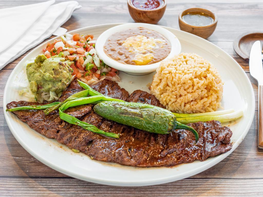 Carne Asada · 10 oz. Lean skirt steak lightly seasoned and charbroiled to perfection. Served with guacamole, pico de gallo, garnished with grilled green onions and roasted jalapeno pepper.