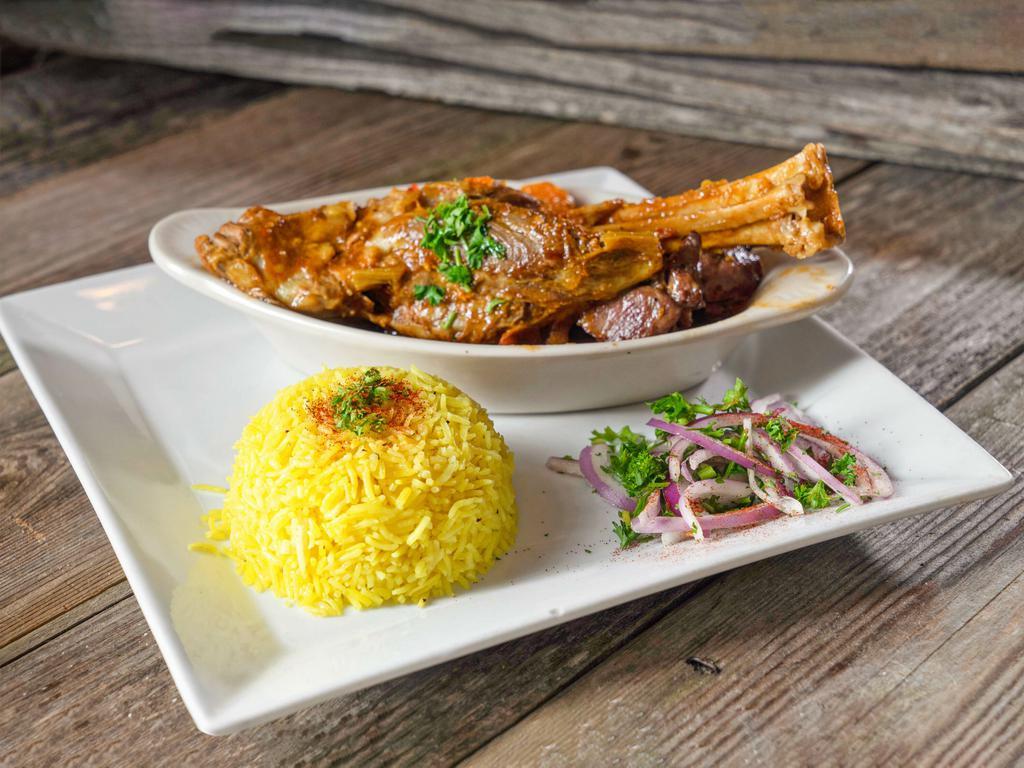 Braised Lamb Shank · Braised lamb shank in tomato sauce with vegetables. Served with rice. Gluten free.
