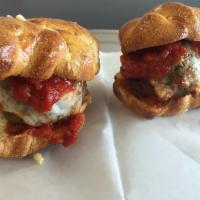 Garlic Knot Meatball Sliders · 3 sliders. House-made meatballs on large garlic knots with a melted mozzarella cheese blend ...