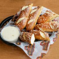 Pretzel Sticks · Salted, baked and served with choice of house queso or honey mustard.