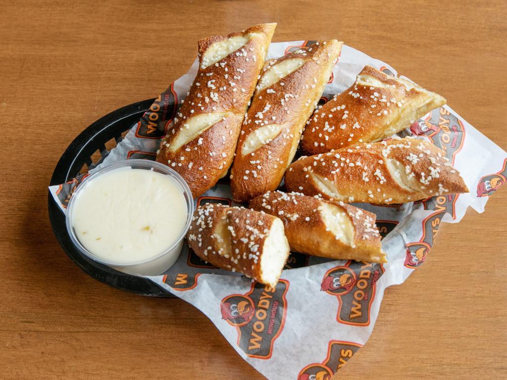 Pretzel Sticks · Salted, baked and served with choice of house queso or honey mustard.