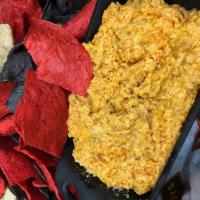 Buffalo Chicken Dip · Gooey blend of cheese, Buffalo sauce and chicken made in house. Served with tri-color tortil...