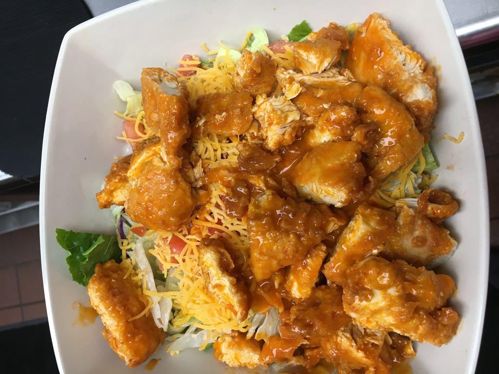 Chicken Varsity Salad · Fried or grilled chicken on a bed of mixed greens, topped with cheddar, tomato, red onion and croutons. Served with choice of dressing.