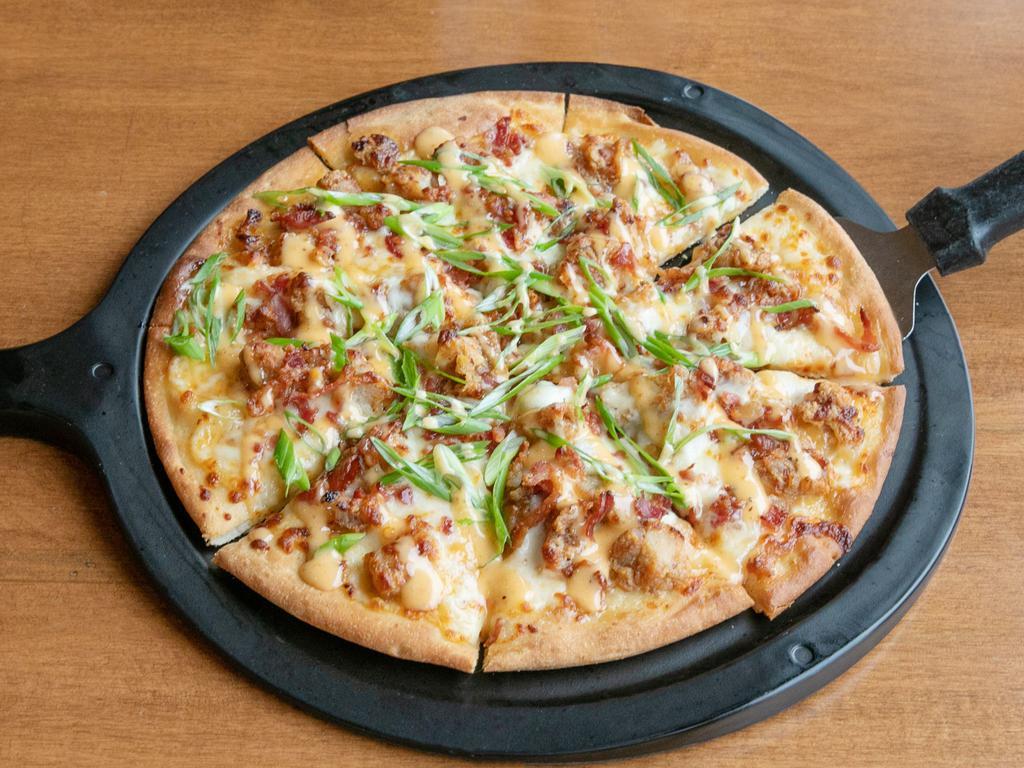 NEW 12 inch Woody's Pizza · Woody's sauce, fried chicken, mozzarella and provolone. Topped with crumbled bacon and green onions.
