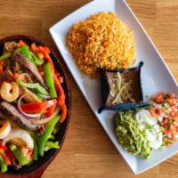 Steak Fajitas · Served with rice, beans, sour cream, guacamole, and tortillas.