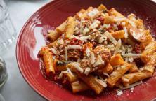 Rigatoni with Italian Sausage · Tube pasta tossed in a zesty tomato sauce with Italian sausage and topped with grated grana padano cheese.