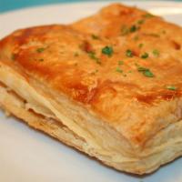 Tiropita · Cheese pie with feta and herbs baked in phyllo dough. 
