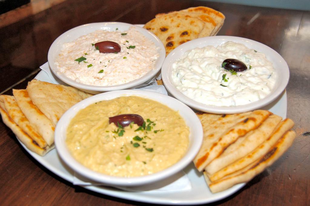 Pikilia · Assorted spreads including hummus, tzatziki and tirokafteri, served with two warm pita breads. 