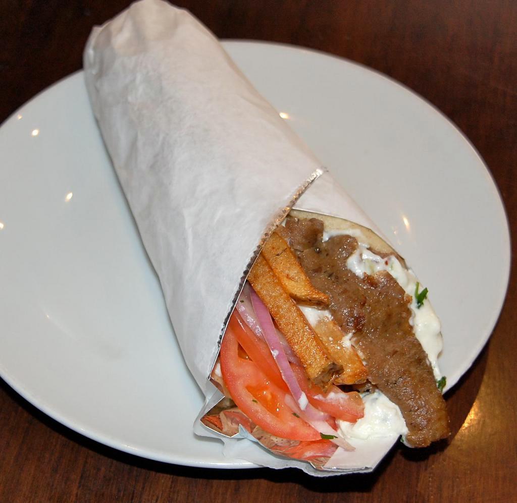 Bifteki Pita Sandwich · Greek style freshly ground beef skewer seasoned with herbs and spices. Topped with tomato, red onion, fresh cut fries, and tzatziki sauce. Add feta cheese and extra tzatziki sauce for an additional charge.  