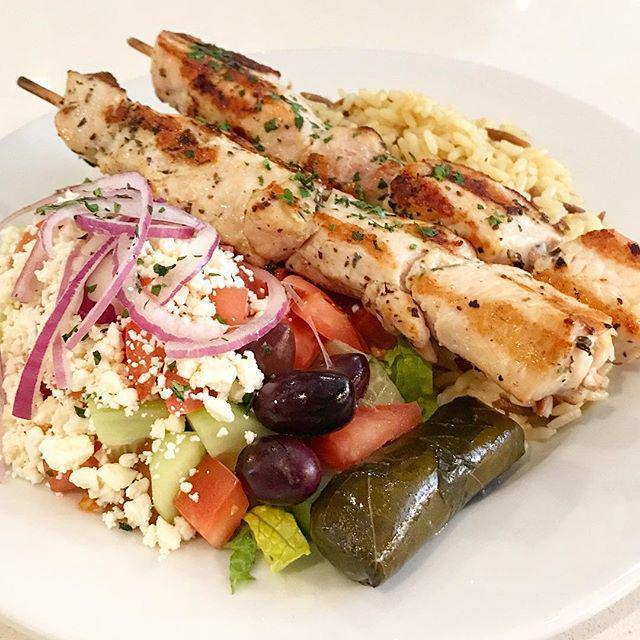 Chicken Souvlaki Platter · Two sticks of tender grilled all white meat chicken cubes seasoned with herbs. Includes a choice of rice or fries, with horiatiki salad. Served with one pita bread and a small tzatziki sauce.   