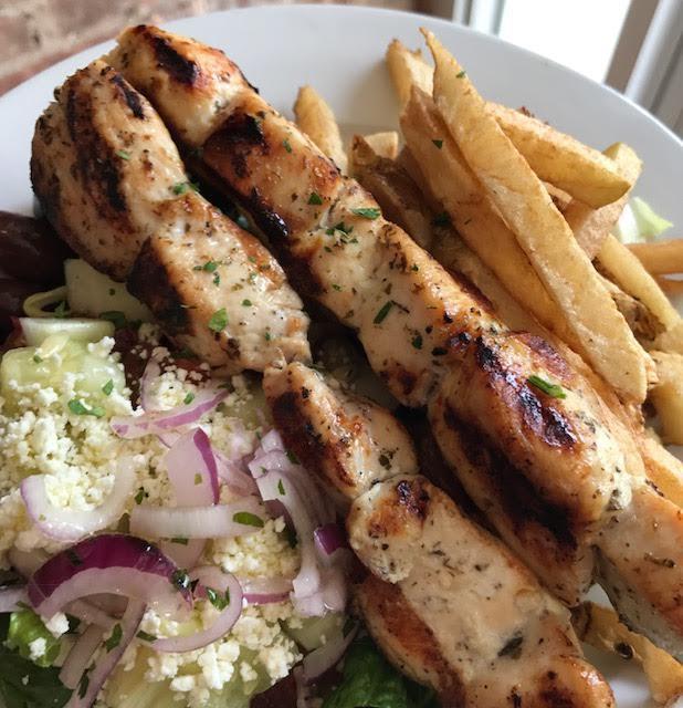 Pork Souvlaki Platter  · 2 sticks of tender grilled pork cubes seasoned with herbs. Includes a choice of rice or fries, with horiatiki salad. Served with 1 pita bread and a small tzatziki sauce. Extra sauce and pita for an additional charge. 