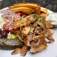 Greek Style Pork Gyro Platter · Slow roasted rotisserie Pork.  Includes a choice of rice or fries, with horiatiki salad. Ser...