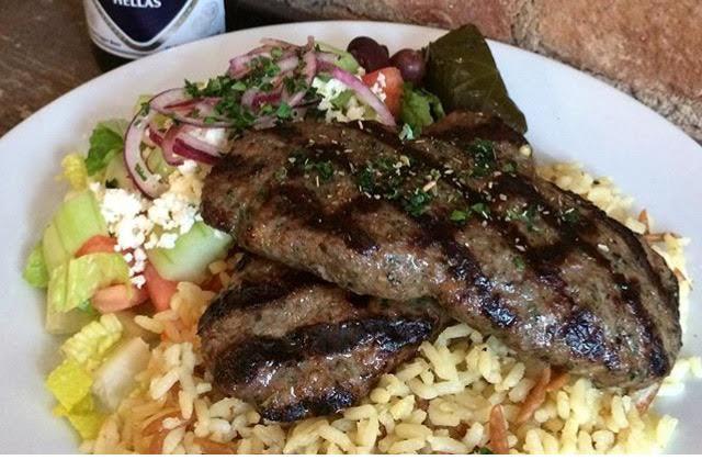 Bifteki Platter · Two Greek style freshly ground beef patties seasoned with herbs and spices. Includes a choice of rice or fries, with horiatiki salad. Served with one pita bread and a small tzatziki sauce.