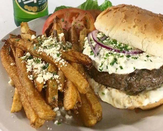 Deluxe Greek Style Mamma's Burger · Freshly ground beef seasoned with Greek herbs, spices and crumbled feta. Served with fresh cut fries. 