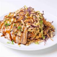 Asian Sesame Salad · Mixed cabbage slaw mix, crispy won tons, carrots, green onions, and sesame seeds. Served wit...