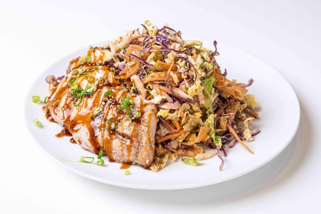 Asian Sesame Salad · Mixed cabbage slaw mix, crispy won tons, carrots, green onions, and sesame seeds. Served with a side of Asian sesame dressing. (Price may vary depending on protein)