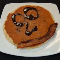Kid's Chocolate Chip Pancake · 1 buttermilk pancake with chocolate chips and a slice of bacon.