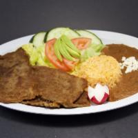 Plato de Milaneza · Breaded thin steak, served with rice, pinto beans, salad and corn tortillas.