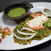 Ensalada de Nopales · Cactus mixed with onions, topped with cilantro and fresco cheese.
