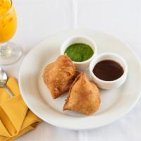 Vegetable Samosa  · 2 pieces. Crispy and flaky crust stuffed with potatoes, peas and nuts.