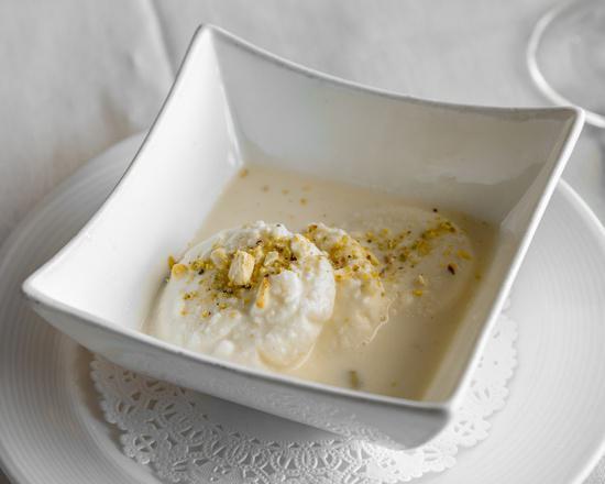 Rasmalai · 2 pieces. Homemade cheese in special condensed milk flavored with rose water and garnished with pistachio.