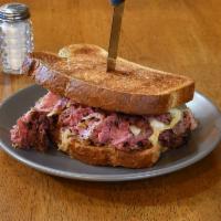 Grilled New York Style Reuben Sandwich · 100 year old German-recipe sauerkraut, pastrami, Swiss, and house mustard on toasted New Yor...