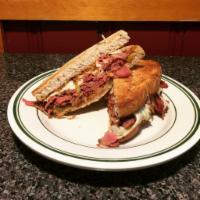 Grilled House Style Reuben Sandwich · 100 year old German-recipe sauerkraut, pastrami, Swiss, and house mustard on toasted New Yor...