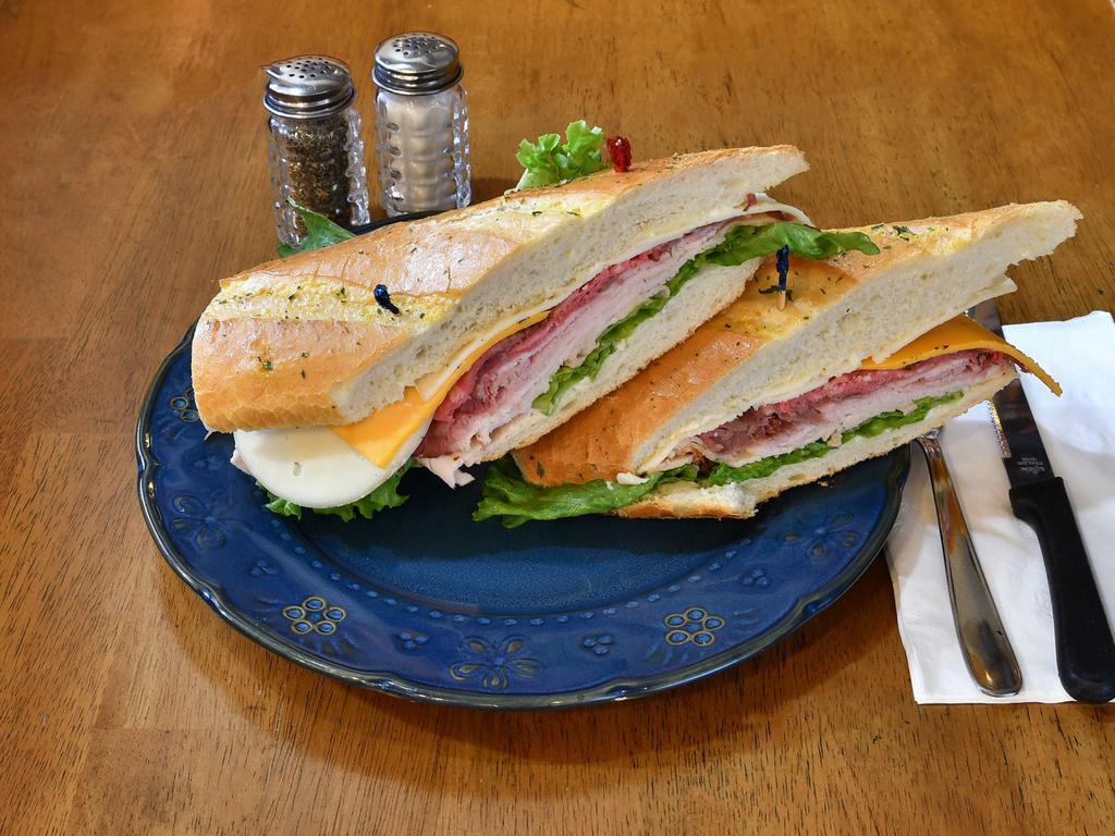 French Club Sandwich · Turkey, ham, roast beef, sharp cheddar, provolone, mayo, house mustard, and lettuce on a French roll.