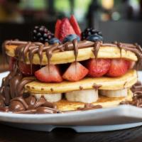 Nutella Fruit · Waffle or Pancakes with banana, strawberry, Nutella and powdered sugar.