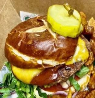 The Hickory Stick Burger · Choice of protein, Leidy's thick-cut bacon, Memphis BBQ sauce, cheddar cheese, lettuce, tomato and sliced red onion with Caesar aioli on a toasted pretzel roll.