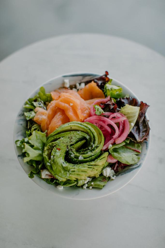 Smoked Salmon Salad · Spring mix, goat cheese, smoked salmon, avocado, pickled onions, housemade olive oil dressing.