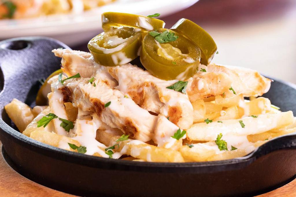Chicken Alfredo Fries · It's our signature dish, except on French fries! We start with golden fries, then layer on thick slices of grilled chicken tossed on our made-fresh-daily, creamy Alfredo sauce and top it with jalapeños for a touch of heat.