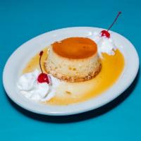 Flan · Delicious homemade flan served with a double scoop of whipped cream.