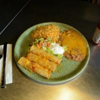 Taquitos Rancheros · 3 crispy rolled corn tortillas stuffed with your choice of meat served with guacamole and so...