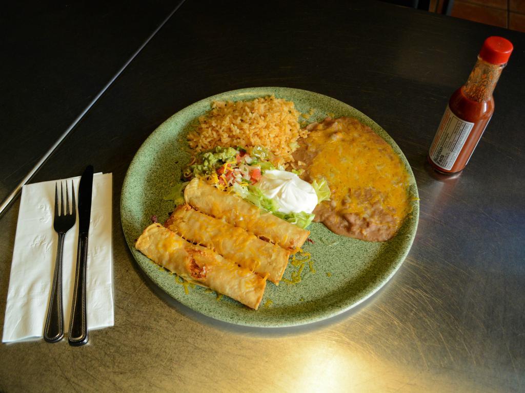 Taquitos Rancheros · 3 crispy rolled corn tortillas stuffed with your choice of meat served with guacamole and sour cream.