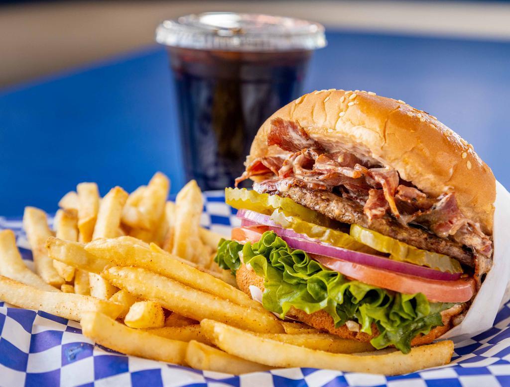 Colossal Burger Combo · Sesame seed bun, hamburger patty, juicy pastrami, lettuce, tomato, red onions, pickles, and 1000 Island dressing. Comes with French fries and a drink.