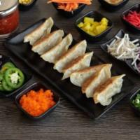8 Piece Pan Fried Dumplings · Served with choice of meat.