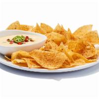 Chips ＆ Queso · It ain’t rocket surgery. It’s a creamy blend of melted cheeses mixed with roasted red and gr...