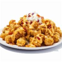 Lots-A-Tots · This one practically named itself. A pile of tots fully loaded with bacon, cheese, sour crea...