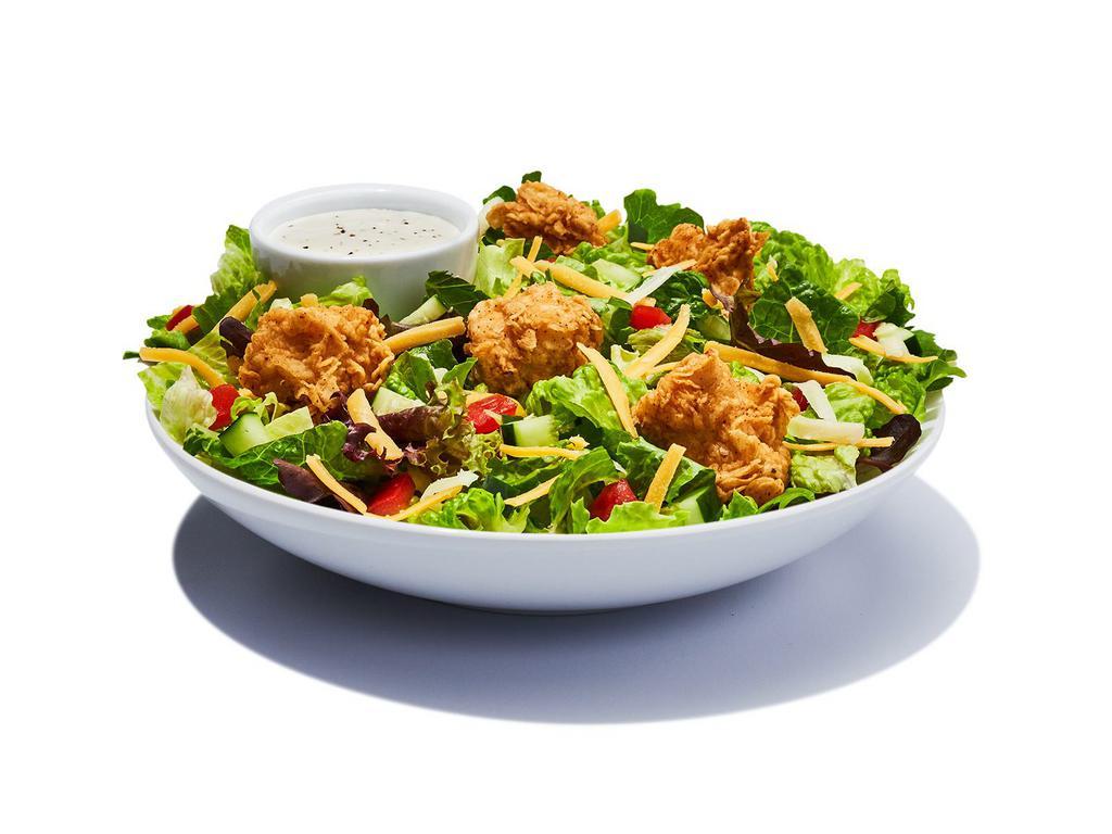 Garden Salad · Spring mix greens piled with diced tomatoes, crips cucumbers, cheddar cheese, Monterey Jack cheese and croutons and your choice of salad dressing.