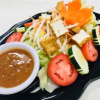 20. Thai Salad · Lettuce, tomatoes, carrots, bean sprouts, cucumbers and tofu served with sweet vinegar and p...