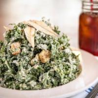 Kale Caesar. · Boquerones, butter croutons, parmesan, creamy dressing