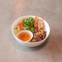 Grilled Pork Chop Noodle · Bun thit heo nuong.  Grilled pork, egg roll, and fresh veggies topped with roasted peanuts o...