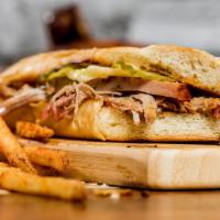 BBQUBAN · Pulled Pork, Ham, Swiss Cheese, Holy Gold Sauce. Includes Fries and a Drink. 