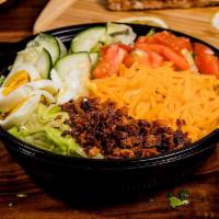 Cobb Salad · Lettuce piled with bacon, eggs, cheese, tomatoes, cucumber and corn with choice of smoked ch...