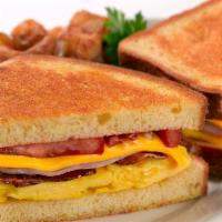 Brioche Breakfast Sandwich · Scramble egg, smoked bacon, ham, grilled tomatoes, melted cheddar cheese and mayonnaise on g...