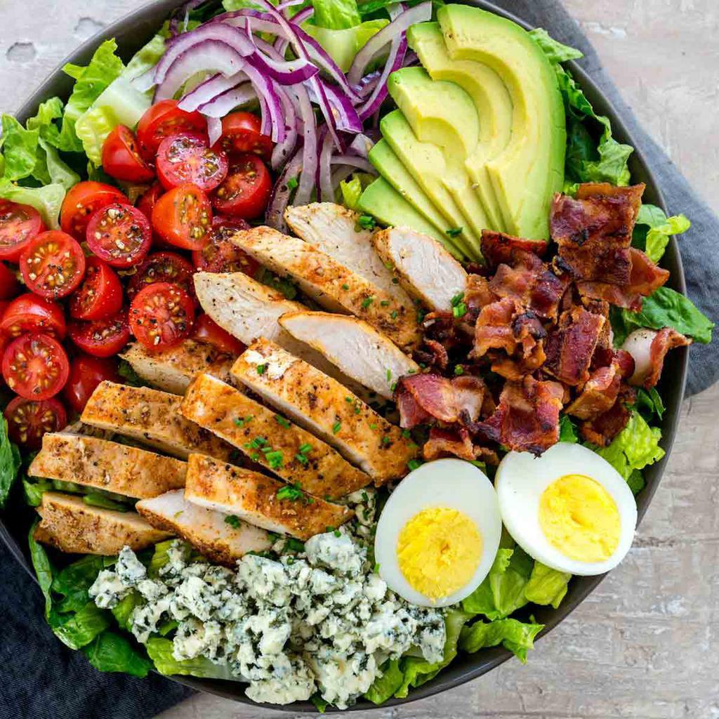 California Cobb Salad · Grilled chicken, avocado, blue cheese, smoked bacon, corn, cherry tomatoes, red onions, hard boiled egg over mixed mesclun greens.