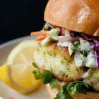 Fish Filet Sandwich · Served on a brioche bun, avocado, red onions, lettuce, tomatoes, and homemade chipotle tarta...