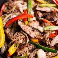 Steak Fajitas · Marinated strips of steak sauteed with onions, peppers and mushrooms. Served with homemade b...