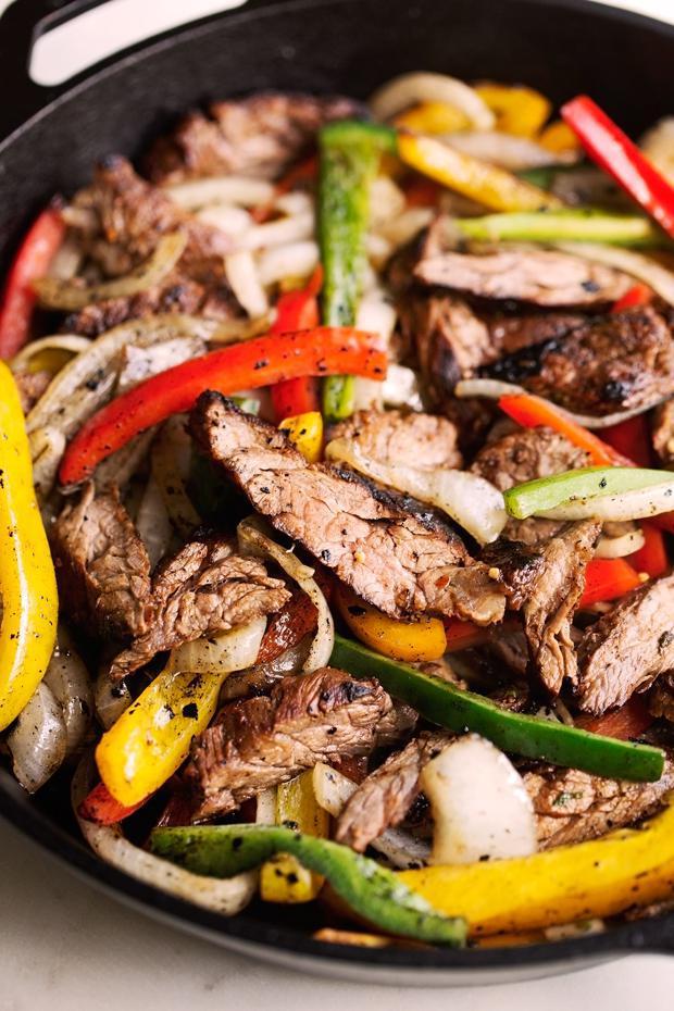 Steak Fajitas · Marinated strips of steak sauteed with onions, peppers and mushrooms. Served with homemade black beans, rice, guacamole, avocado salsa, sour cream, flour tortillas and our traditional pico de gallo.